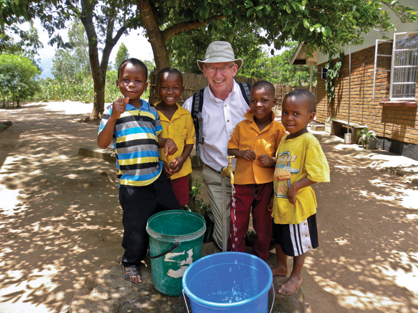 photo of Commissioner Brian Peddle with Malawian children
