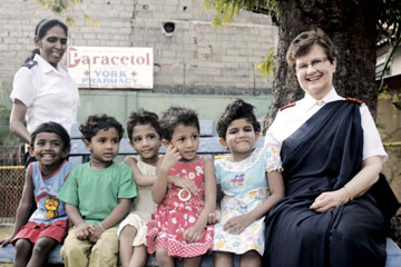 General Linda Bond with children and a staff member from The Haven Children's Home