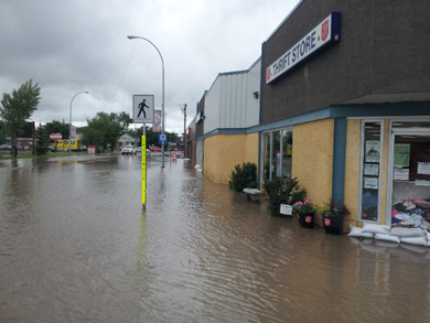 Flood waters reach The Salvation Army's thrift store and family services and church office in High River, Alta., on June 20