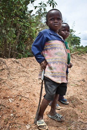 Two young boys stand alone on the side of the road in Liberia