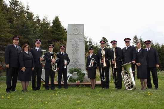 Colonel Mark Tillsley, chief secretary; Colonel Sharon Tillsley, territorial secretary for women's ministries; members of the Canadian Staff Band; Majors Anne and Brian Venables, divisional director of women's ministries and divisional commander, Quebec Division, gather at the Canadian Pacific Monument in Rimouski, Quebec