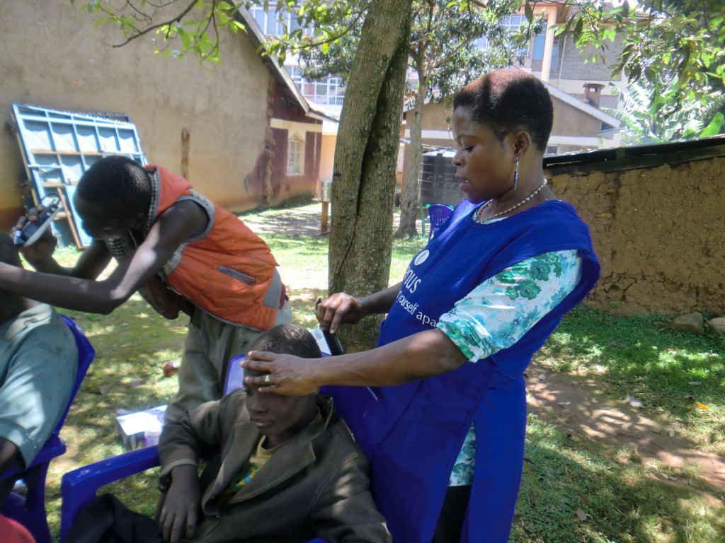 Womenn who attend The Salvation Army Prostitute Survivor Program in Kenya West cuts hair during a program that helps street boys learn about personal hygiene. Women in the program build self-esteem and learn other ways to build income. Most women were forced to the streets in order to feed, clothe and school their children.