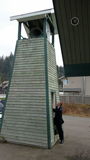 Cadet David Dale rings the bell to call the village of Gitwinksihlkw to worship
