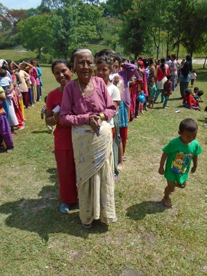 The Salvation Army distributes food to those in need at a golf course camp in Nepal