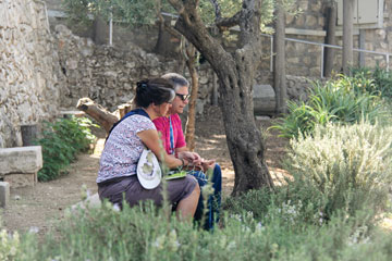 Mjrs Lynn and Brian Armstrong share a moment of prayer in the Garden of Gethsemane