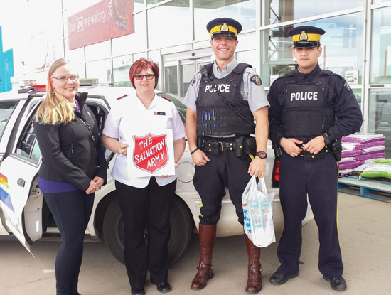 When the food bank's shelves are bare, Lloydminster Corps can count on the support of its community, including the local RCMP, making a donation to Tiffany Frank and Mjr Lisa O'Doherty