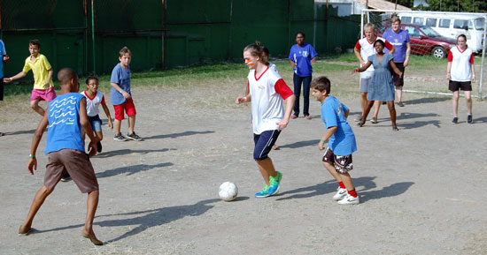 Brazilian children at the Méier Education Centre show mission team members how to play their national game