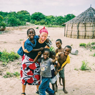 Feakins with children in Mozambique, where she went on a short-term mission trip in 2005