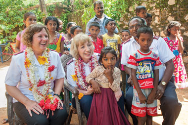 Major Brenda Murray, director of world missions, Commissioner Susan McMillan and Colonel Nihal Hettiarachchi, then chief secretary of the Sri Lanka Territory, are welcomed to a community that provided new homes after the tsunami. The visit coincided with a wedding, and they were graciously invited to be part of the celebration.