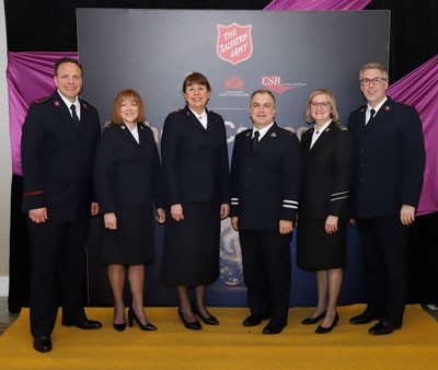 Six people in Salvation Army uniforms standing together 