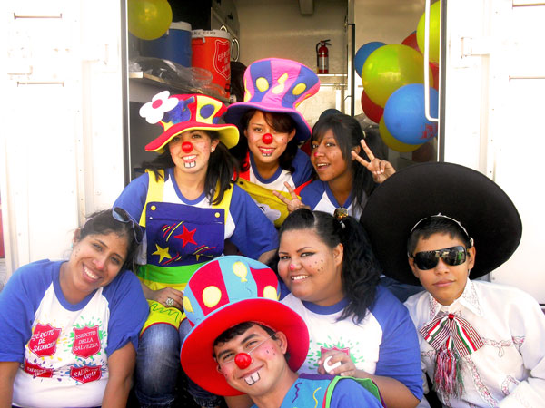 Salvationist young people dressed in bright clothes to attract the attention of passersby