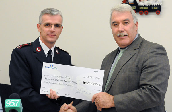 From left, Mjr Morris Vincent, AC, Maritime Div, receives a cheque for $400,000 for the Good Neighbour Energy Fund from John MacDonell