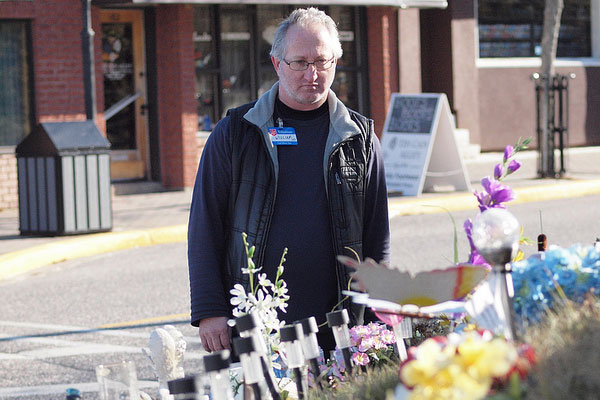 William Guppy, an Elliot Lake, Ont., thrift store volunteer stands by a memorial at the Algo Centre mall