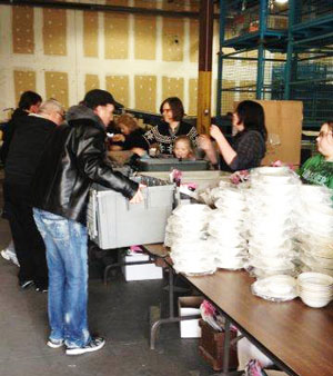 Employees and volunteers from Gateway in Toronto prepare care packages for men leaving the shelter