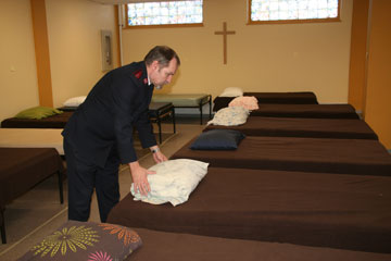 Captain Ben Lippers makes beds at the Regina cold weather shelter
