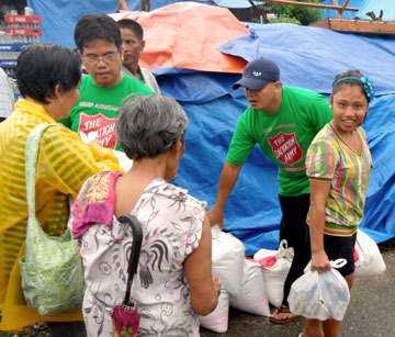 Salvation Army team members distribute food and other essentials to typhoon victims