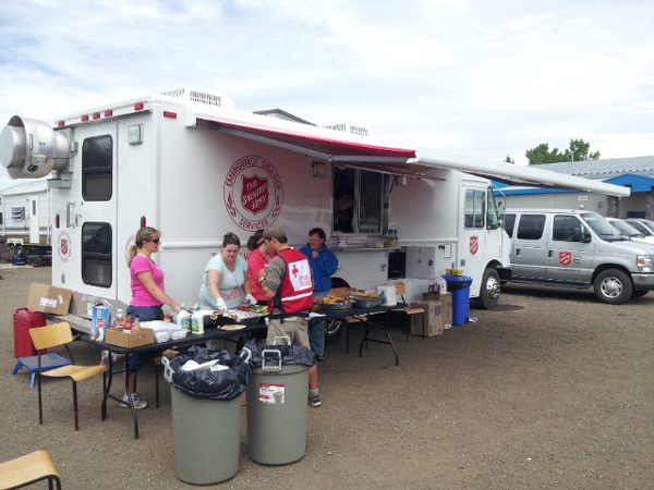 Volunteers serve meals at the evacuation centre in Blackie, Alta.