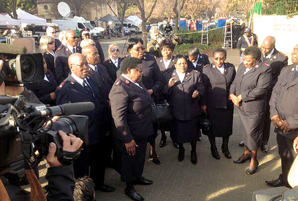 TV cameras capture the moment as Salvation Army officers sing outside the hospital where Nelson Mandela is being treated