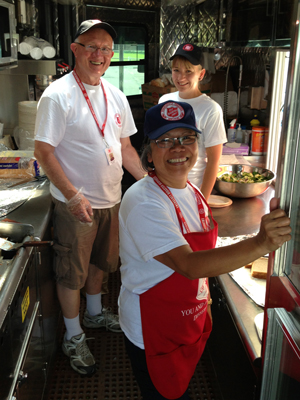 Volunteers serve food from a Salvation Army canteen in High River