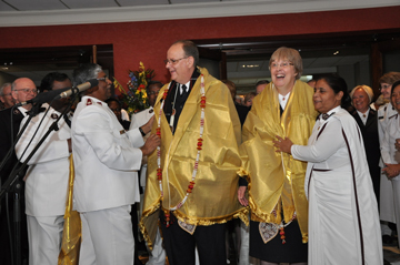 Indian commissioners present General André Cox and Commissioner Sylvia Cox with traditional cultural gifts following the General's election
