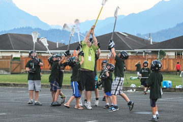 Tina Ortutay and her husband, Mike (centre), teach lacrosse at Kids Games in Chilliwack, B.C.