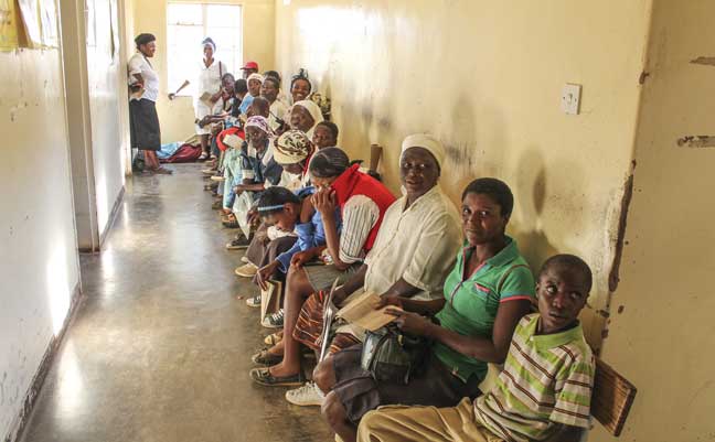 People wait to see doctors in the out-patient department. Many travel for quite a distance to access the medical services provided by the hospital