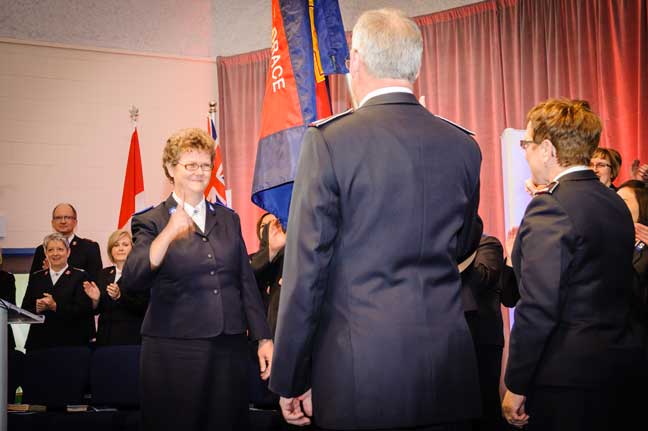 Cadet Donna Downey salutes Commissioners Brian and Rosalie Peddle, territorial leaders