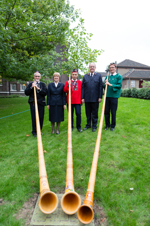 An alpenhorn trio contributes to the General's welcome service