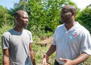 Osselin speaks with project manager Jodel Pierre