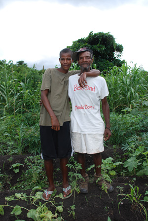 Jonas and his dad stand in their field of crops