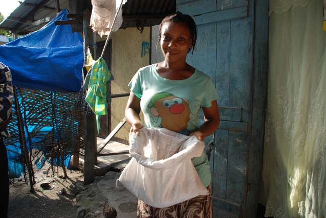 Carline shows a bag of peas that she sells from her home