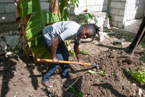 Chatelier digs a trench so she and her team can install pipes