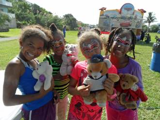 Four young girls have their faces painted at the Army's community celebration