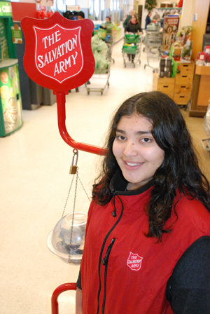 Kettle volunteer Sofia Vasquez-Rivas collects donations at a Loblaws in Toronto during the 2013 kettle campaign