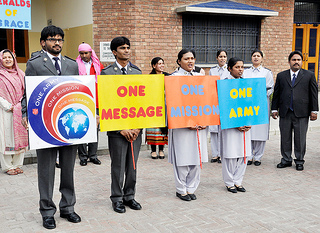 A group of cadets hold signs saying 