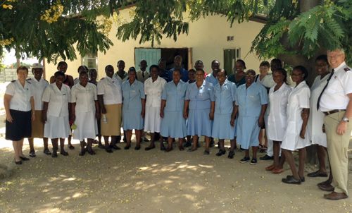 Commissioner Brian Peddle, far right, and Commissioner Rosalie Peddle, far left, with the staff of the Bumhudzo Hospital Home in Zimbabwe