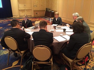 Commissioner Silvia Cox (centre) participates in round-table discussions at the Global Conversation