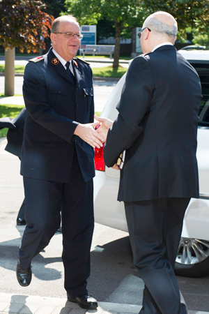 Colonel Mark Tillsley, chief secretary, greets General Cox as he arrives at territorial headquarters