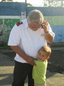 A little boy runs to the Salvation Army Officer expressing great joy