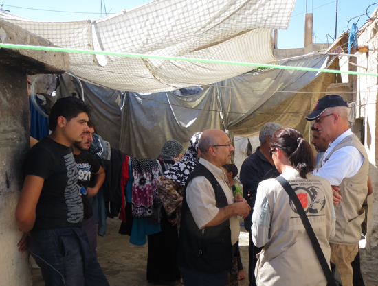 Salvation Army workers visit Syrians in an informal community