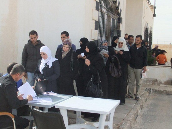 Syrians and Jordanians line up to receive their winterization kits