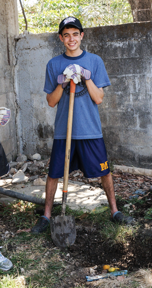 Michael Herbert digs a trench