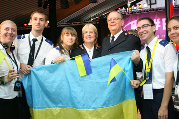 Ukrainian delegates wave their national flag with General André Cox and Commissioner Silvia Cox