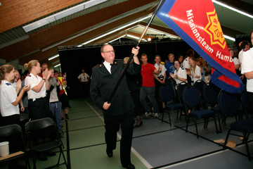 General André Cox waves the Salvation Army flag in celebration