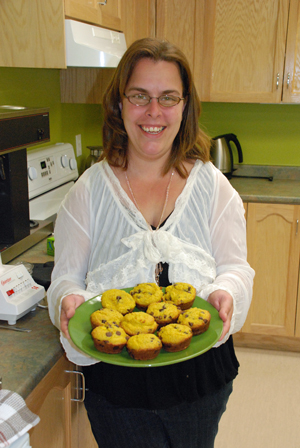 Krista Hynes holds a batch of freshly baked muffins