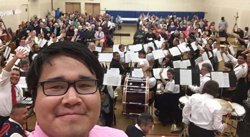 Salvationist Alex Stoney snaps a selfie with the 60-piece band during Upper Skeena Circuit's massed-band concert 