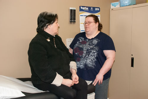 Nurse practitioner Gail Bishop talks with client, Janice
