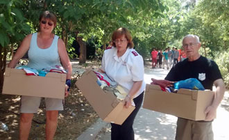 Salvation Army personnel collect clothing to give to refugees