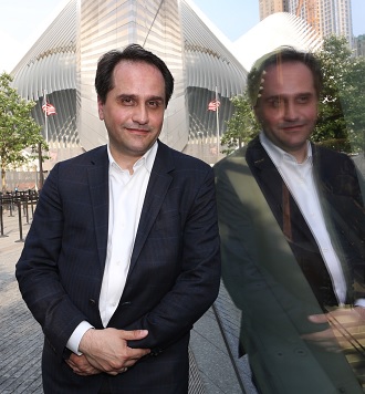 Nick Zigomanis stands next to the 9/11 Memorial Museum Pavilion