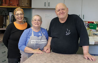 Volunteers Natalie Austin, Nadine Lazenby and Rod Lazenby make delicious meals for the program